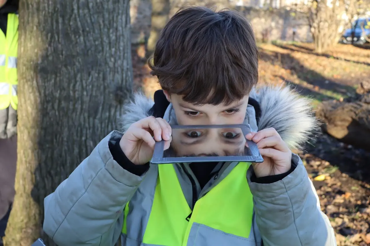 Child looking at reflective surface